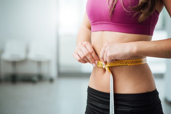 depositphotos_80139016-stock-photo-slim-woman-measuring-her-thin